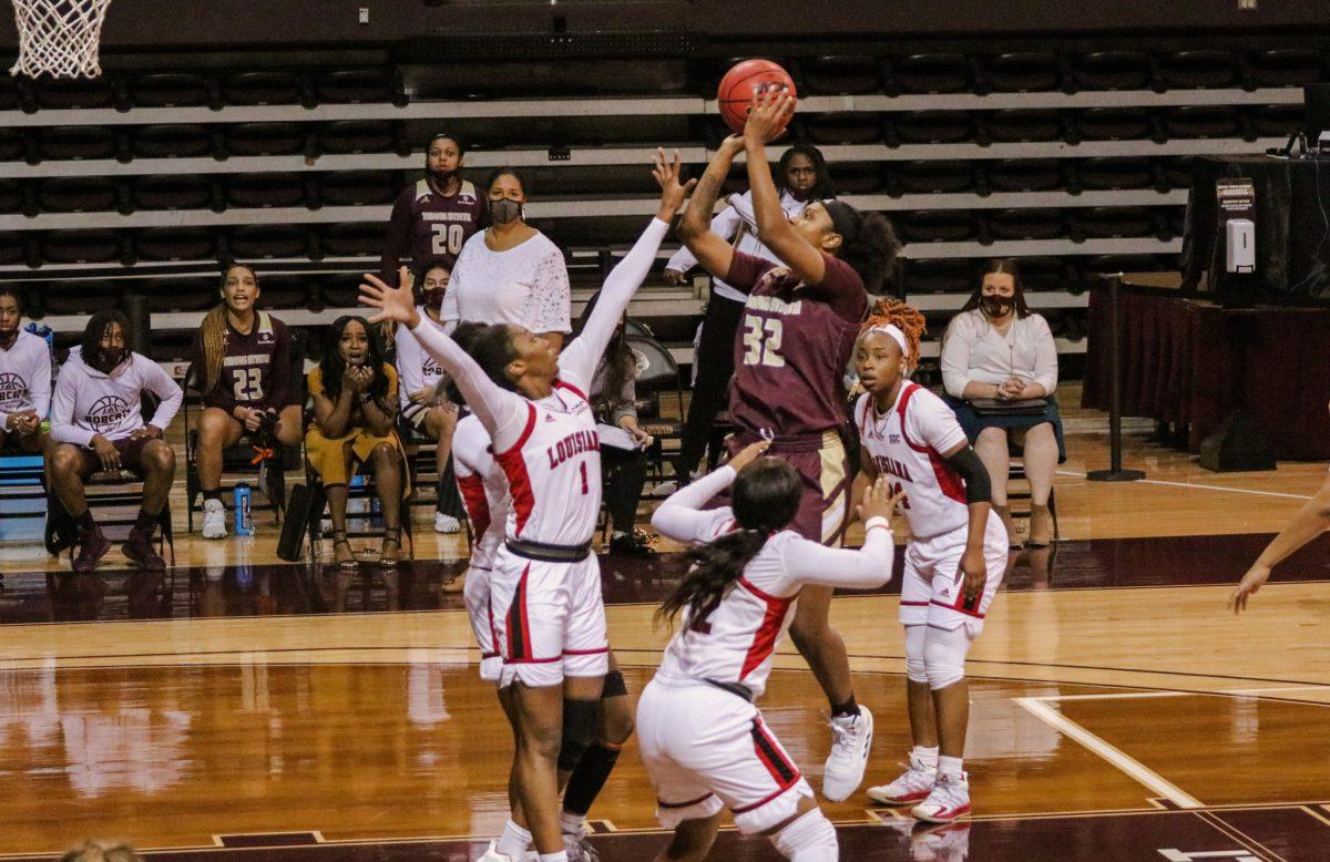 Texas State junior forward DaNasia Hood (32) shoots the basketball over defenders during the fourth quarter of the game against the University of Louisiana at Lafayette, Saturday, Jan. 2, 2021, at Strahan Arena. The Bobcats lost 67-41.