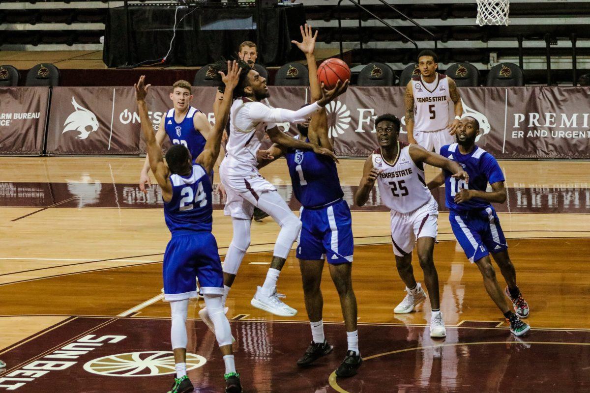 Texas State senior forward Isiah Small (1) jumps through Our Lady of the Lake University defenders to get to the basket, Saturday, Dec. 12, 2020, at Strahan Arena. The Bobcats lost 61-58.