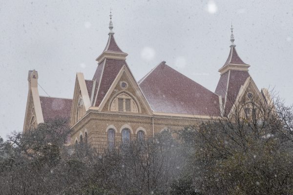 Snow falls upon Old Main, Sunday, Jan. 10, 2021, at Texas State.