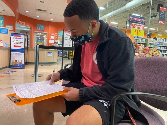 Texas State exercise and sports science senior David Garner signs up for the COVID-19 vaccine, Wednesday, January 13, 2021, at H-E-B. Garner says he hopes to receive his vaccine as soon as it becomes available.