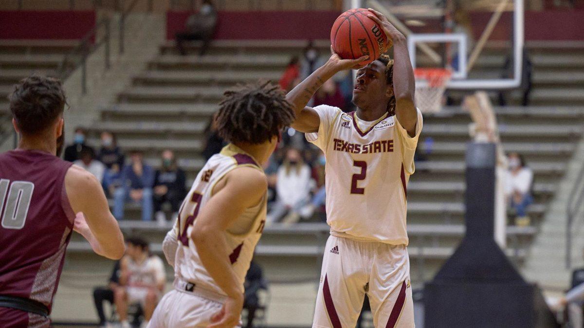 Junior guard Caleb Asberry (2) attempts a shot against the University of Arkansas at Little Rock Trojans during a weekend series against the team. Texas State swept the Trojans, winning its final game 67-56. 