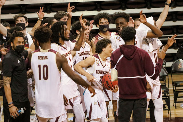 Texas State Bobcats celebrate and sing the school alma mater together after a 79-68 victory over the UTA Mavericks, Saturday, Feb. 13, 2021, at Strahan Arena.