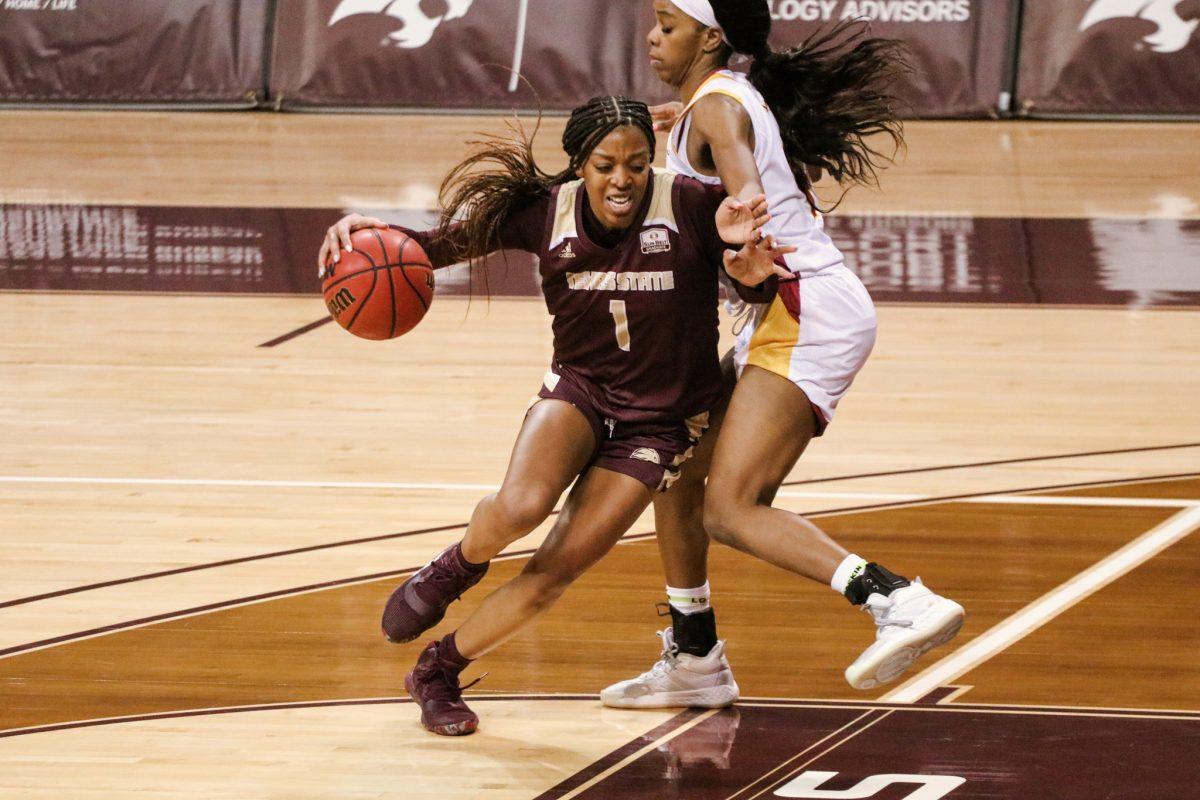 Texas State senior guard Avionne Alexander (1) dribbles past a University of Louisiana Monroe defender in the third quarter of the game, Saturday, Jan. 23, 2021, at Strahan Arena. The Bobcats won 64-50.