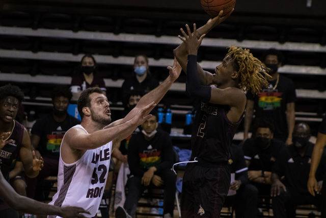 Texas State junior guard Caleb Asberry (2) takes a contested jumper against the Trojans senior center Admir Besovic (52) in a game against the University of Arkansas at Little Rock, Saturday, Feb. 6, 2021, at Strahan Arena. The Bobcats won in overtime 77-67.