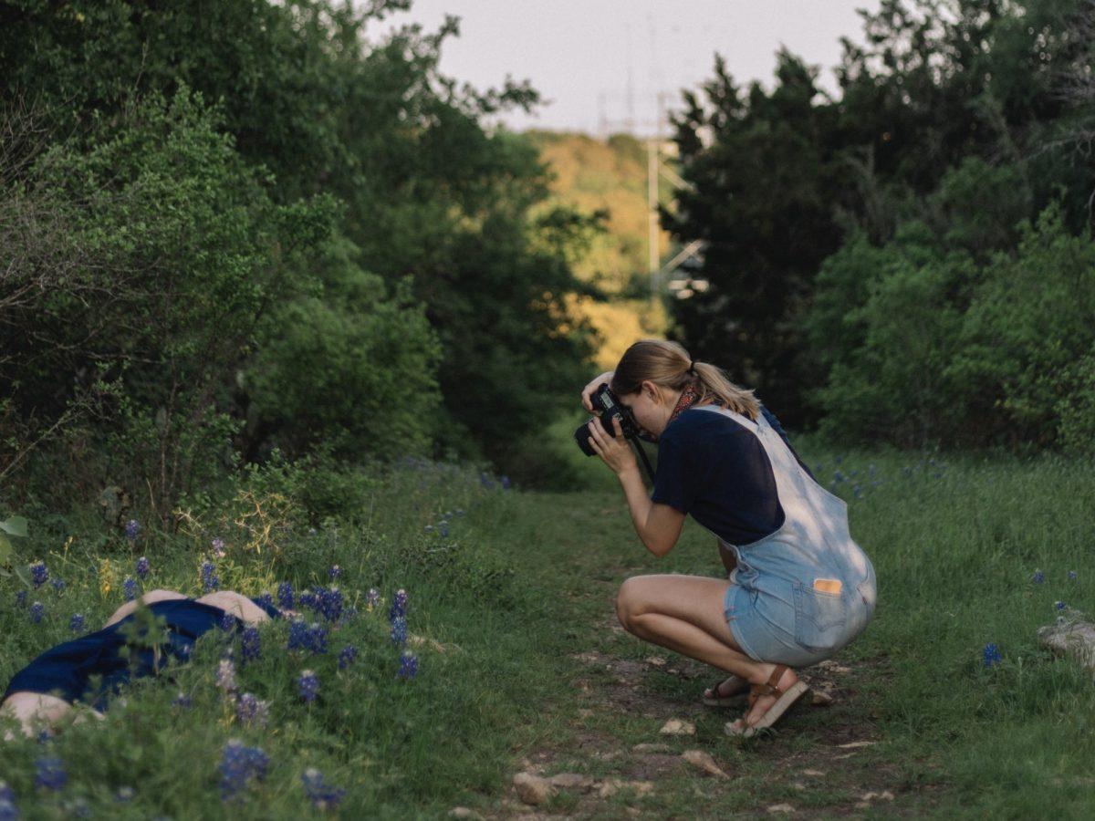Local San Marcos portrait photographer Casey Schlickeisen photographs a Texas State senior during a graduation portrait session, March 26, 2020, at Spring Lake Preserve Natural Area.