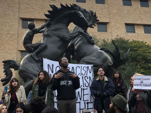 <p>Students, including Tafari Robertson (center), gather around the Fighting Stallions during the March on Clegg, Monday, Feb. 5, 2018, on the Quad.</p>