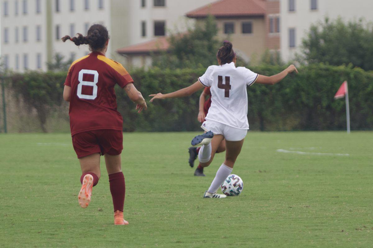 Texas State freshman midfielder Alana Clark (4) prepares to strike the ball while being pursued by University of Louisiana at Monroe junior midfielder Efi Brame (8), Sunday, Oct. 25, 2020, at the Bobcat Soccer Complex. The Bobcats won 3-1 over the Warhawks.