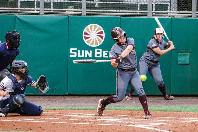Texas State freshman infielder Baylee Lemons (24) swings and hits the softball in the game against Brigham Young University, Thursday, March 11, 2021, at Bobcat Softball Stadium. The Bobcats won 2-1.