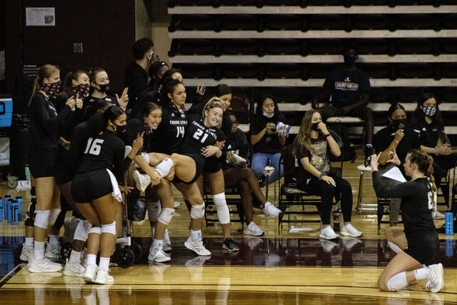 The+Texas+State+womens+volleyball+team+celebrates+on+the+sidelines+after+scoring+a+point+against+the+University+of+Texas+at+Arlington%2C+Saturday%2C+Nov.+14%2C+2020%2C+at+Strahan+Arena.+The+Bobcats+lost+3-0+against+the+Mavericks.