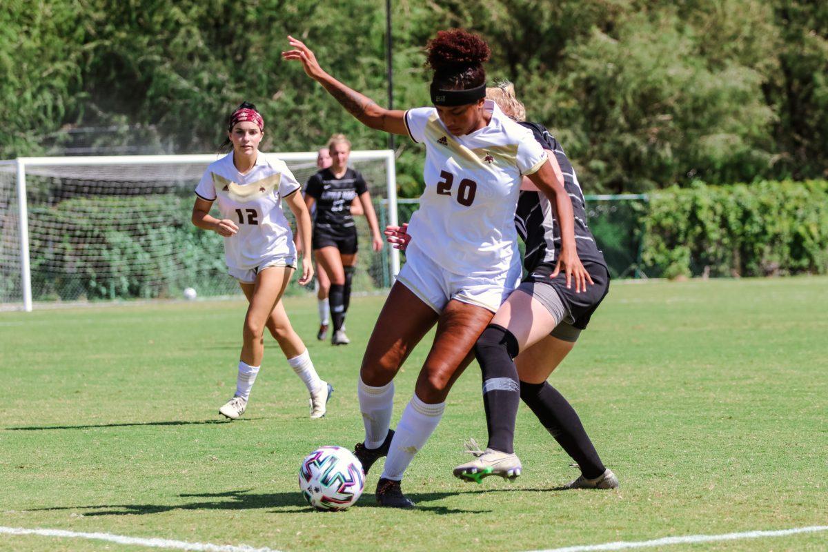 Texas State freshman forward Olivia Wright (20) holds back a University of Arkansas at Little Rock defender as she dribbles the ball down the field, Sunday, Oct. 18, 2020, at Bobcat Soccer Complex. The Bobcats won 2-1 over the Trojans.