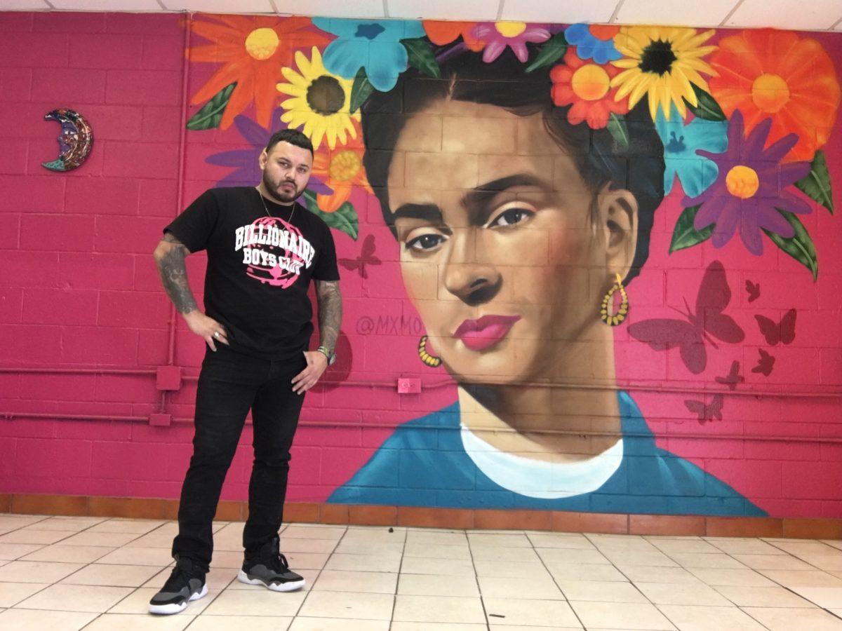 Roger Maximo stands beside a mural of Frida Kahlo on Nov. 18, 2020 at Los Reyes Mexican restaurant, San Antonio.