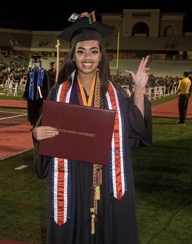 Najha Marshall smiles for a photo after her graduation ceremony in December 2020.