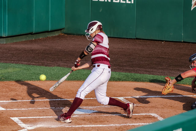 Texas State senior infielder Tara Oltmann (22) swings and hits the softball during the first game of the series against South Alabama, Friday, April 9, 2021, at Bobcat Softball Stadium. The Bobcats lost 3-1.
