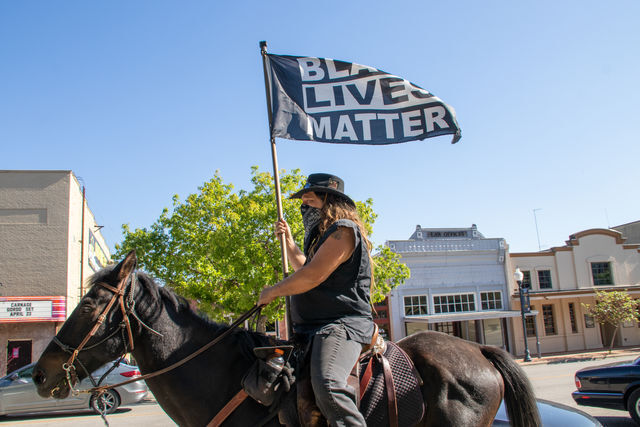 A+protester+on+his+horse+waves+a+Black+Lives+Matter+flag%2C+Saturday%2C+April+24%2C+2021%2C+at+Hays+County+Historic+Courthouse.%26%23160%3BThe+Protest+Against+Police+Murder+was+organized+by+the+San+Marcos+Democratic+Socialists+of+America.