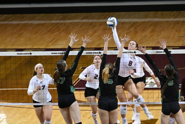Texas State junior middle blocker Jillian Slaughter (8) prepares to spike the ball, Thursday, March 25, 2021, at Strahan Arena. The Bobcats won 3-0.