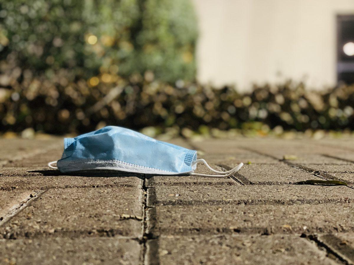 A face mask is left on the ground on Texas States campus. 