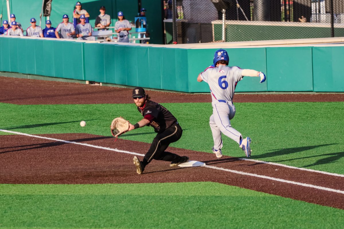 Texas+State+senior+infielder+Cole+Coffey+%282%29+reaches+to+catch+the+baseball+while+a+UTA+player+sprints+to+first+base%2C+Thursday%2C+April+1%2C+2021%2C+at+Bobcat+Ballpark.+The+Bobcats+won+2-0.