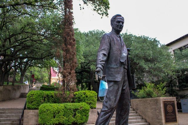 A face mask dangles in the hand of the LBJ statue, Monday, May 25, 2021, at The Quad.