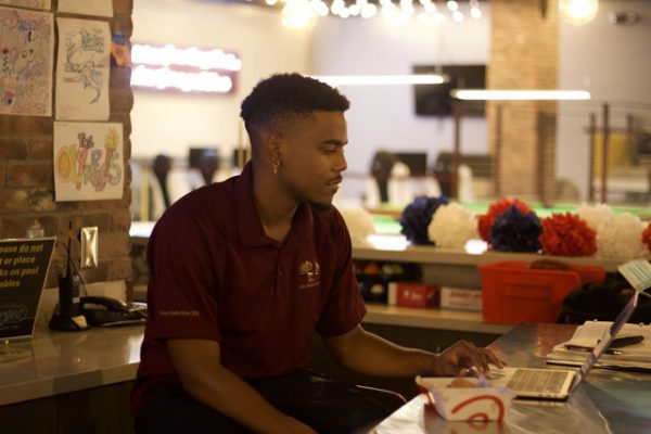 Texas State marketing senior John Martin creates a playlist, Friday, July 23, 2021, at Georges. Martin works there as service assistant.