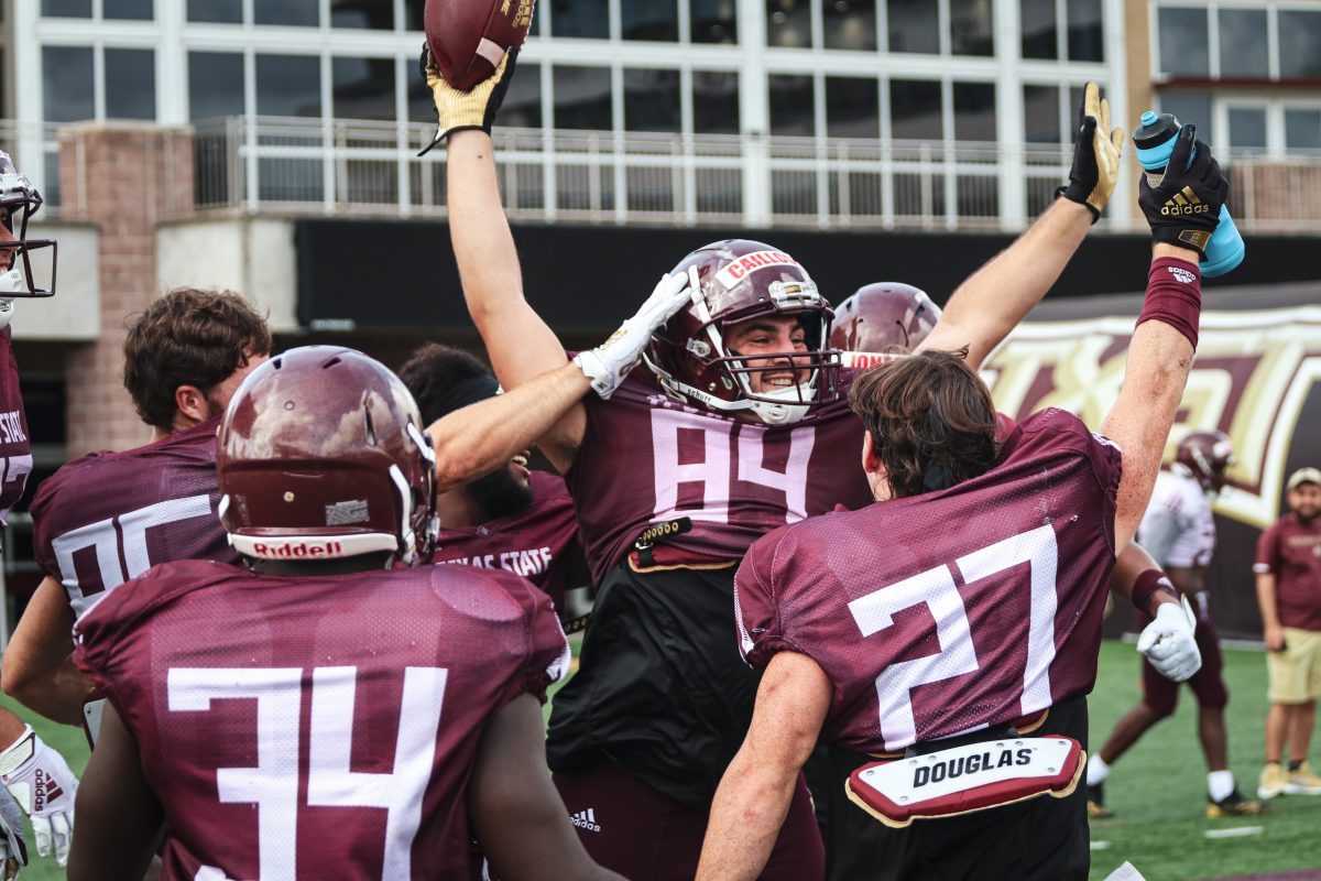 Texas State sophomore tight end Seth Caillouet (84) celebrates with his teammates after scoring a touchdown during a fall camp scrimmage, Wednesday, Aug. 17, 2021, at Bobcat Stadium.