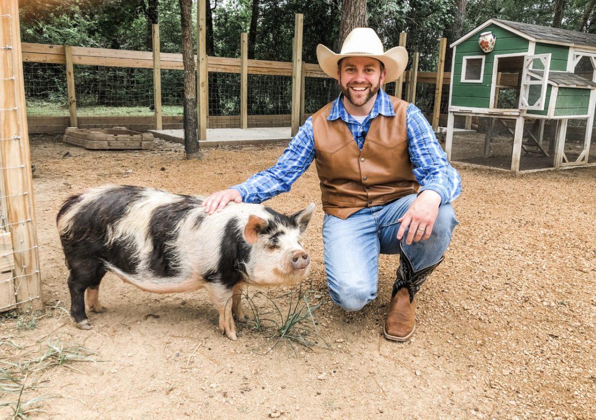 Cowboy Jack smiles and pets a Kunekune pig at The Learning Zoo in Conroe, Texas. In this episode, Cowboy Jack met with a zookeeper to learn and teach viewers about the different animals at the zoo.