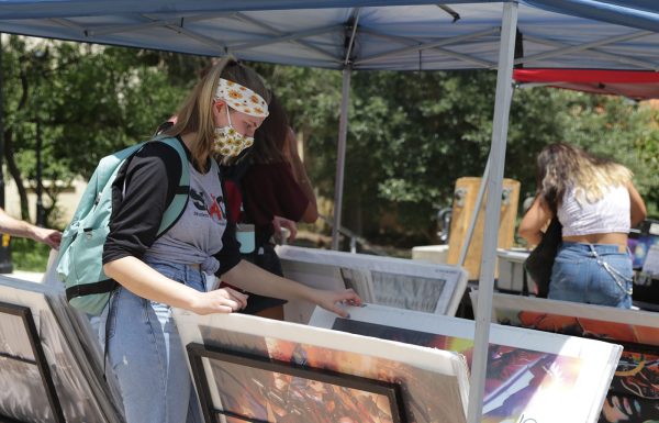 Texas State students look through posters during a poster sale, Monday, August 23, 2021, at Bobcat Trail.