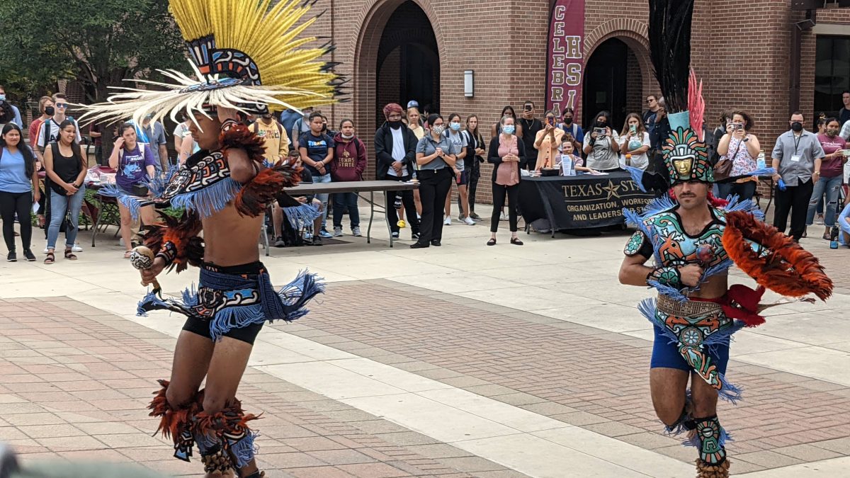 Performers from Mitotiliztli Yaoyollohtli Aztec Dance Company wearing traditional Aztec regalia perform a tribal dance to celebrate HSI Community Day, Monday, Sept. 13, 2021, at the Arch.