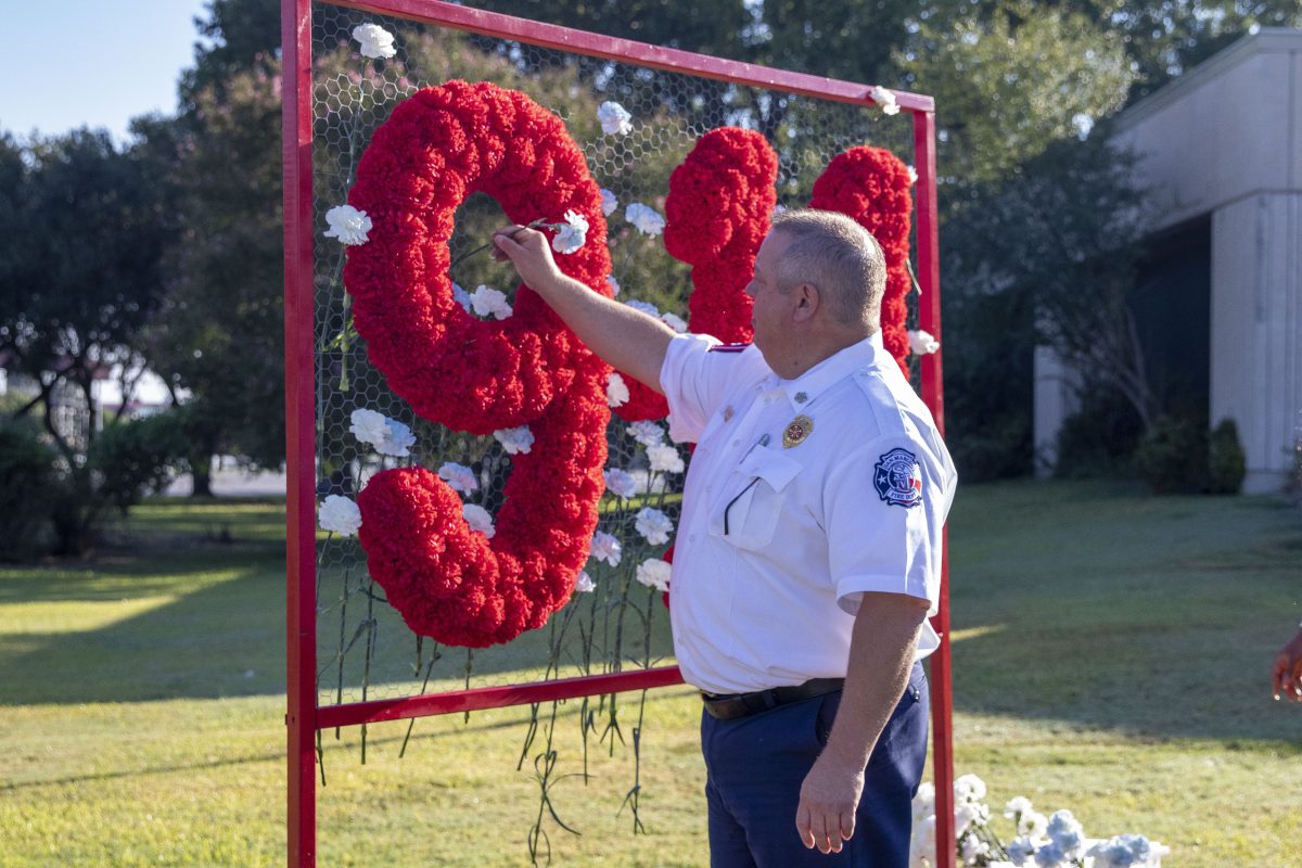 San Marcos Fire Chief Les Stephens places a white rose on the 9/11 memorial during the 20 Year Remembrance Ceremony, Saturday, Sept. 11, 2021, at City Hall.