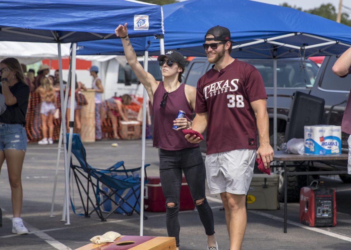 Texas State Bobcat fans play cornhole during tailgate before the football team arrives for the Cat Walk, Saturday, Sept. 4, 2021, at Bobcat Stadium.