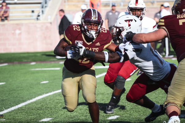 Texas State freshman running back Calvin Hill (22) carries the ball through Troy defenders during the game, Saturday, Oct. 16, 2021, at Bobcat Stadium. The Bobcats lost 31-28.