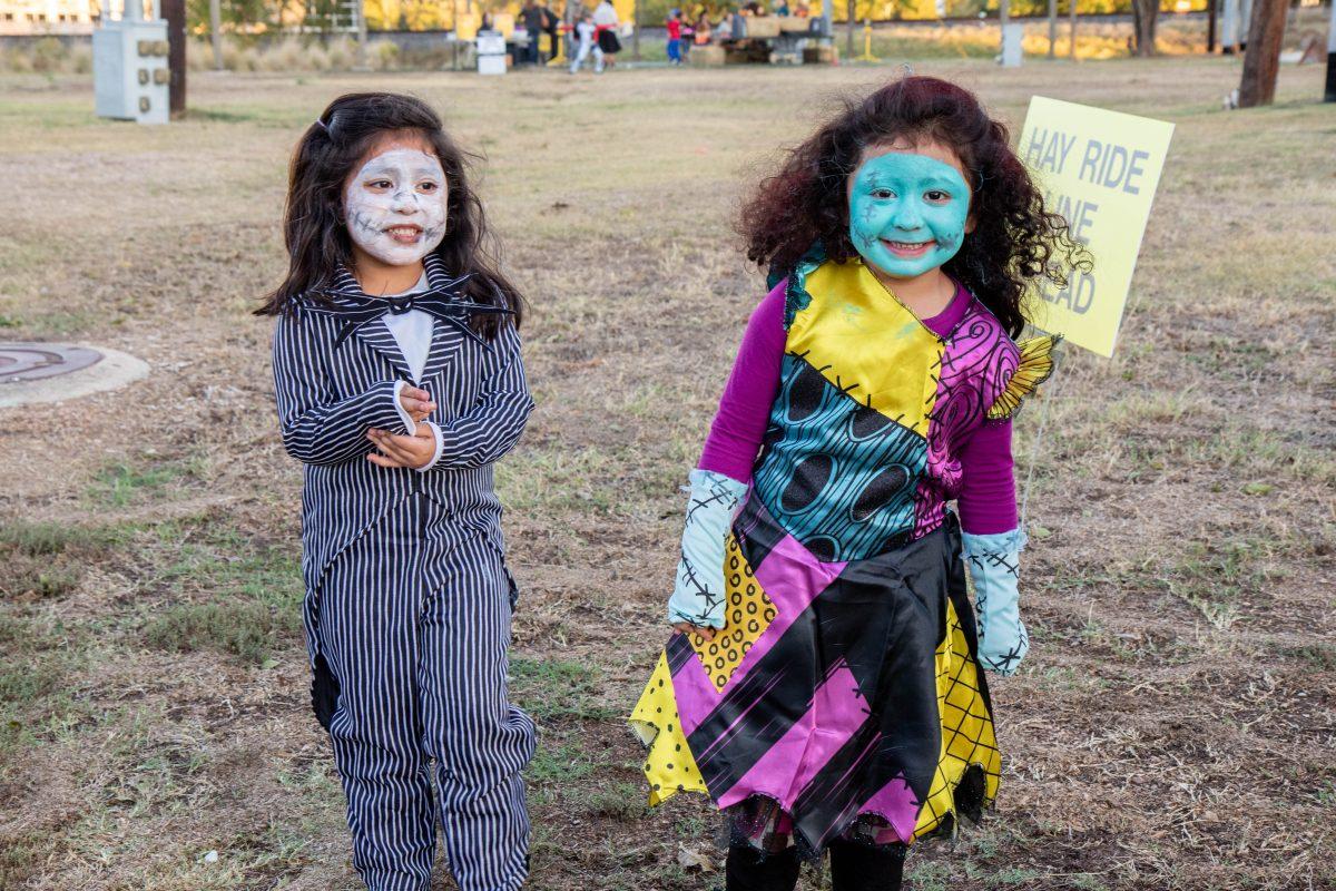 Two girls dressed as Jack Skellington and Sally from The Nightmare Before Christmas smile for a photo at the 2019 Farmer Freds Harvest Fall Carnival.