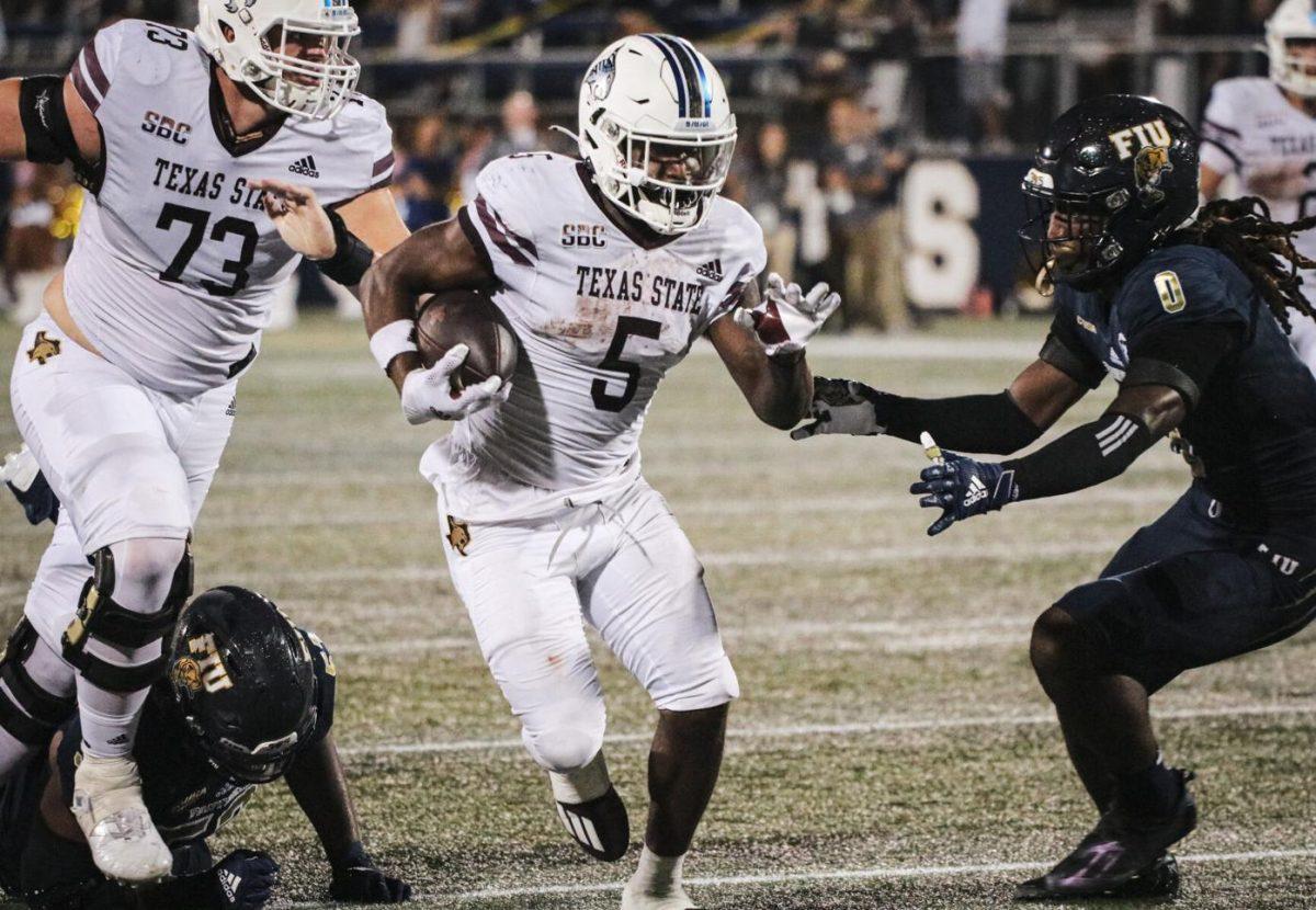 Texas State sophomore running back Brock Sturges (5) sprints past FIU defenders towards the endzone in overtime, Saturday, Sept. 11, 2021, at Riccardo Silva Stadium. The Bobcats won 23-17.