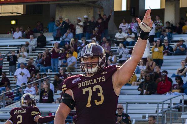 Texas State freshman offensive lineman Dalton Cooper (73) celebrates at the end zone after the Bobcats score a touchdown, Saturday, Oct. 16, 2021, at Bobcat Stadium. The Bobcats lost 31-28.