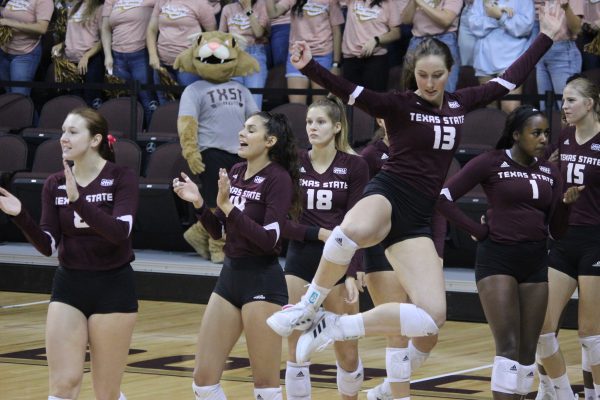 Texas State junior outside hitter Courtney Heiser (13) jumps in celebration after the team scores a point over Coastal Carolina University, Friday, Oct. 22, 2021, at Strahan Arena. The Bobcats won 3-0.