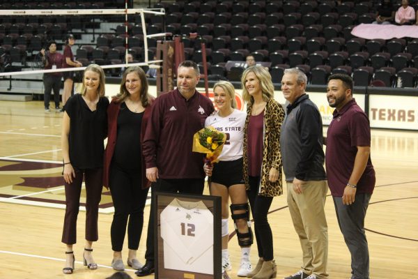 Texas State senior defensive specialist Brooke Johnson (12) and her parents take photos with Bobcat volleyball coaching staff for Senior Day, Sunday, Nov. 7, 2021, at Strahan Arena.