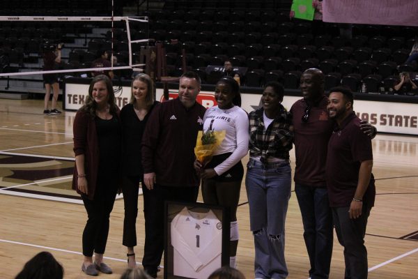 Texas State senior outside hitter Kenedi Rutherford (1) and her parents pose with volleyball coaching staff during Senior Day, Sunday, Nov. 7, 2021, at Strahan Arena.