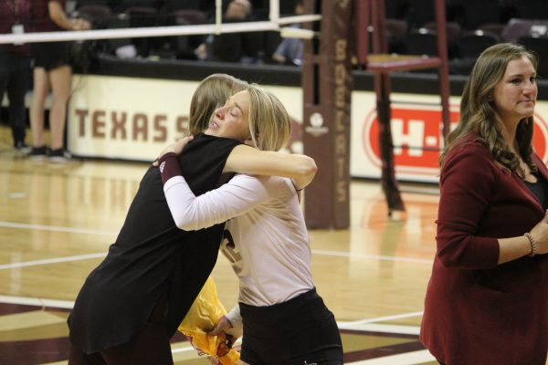 Texas State senior defensive specialist Brooke Johnson (12) hugs graduate assistant Charlie Fouts during Senior Day, Sunday, Nov. 7, 2021, at Strahan Arena.