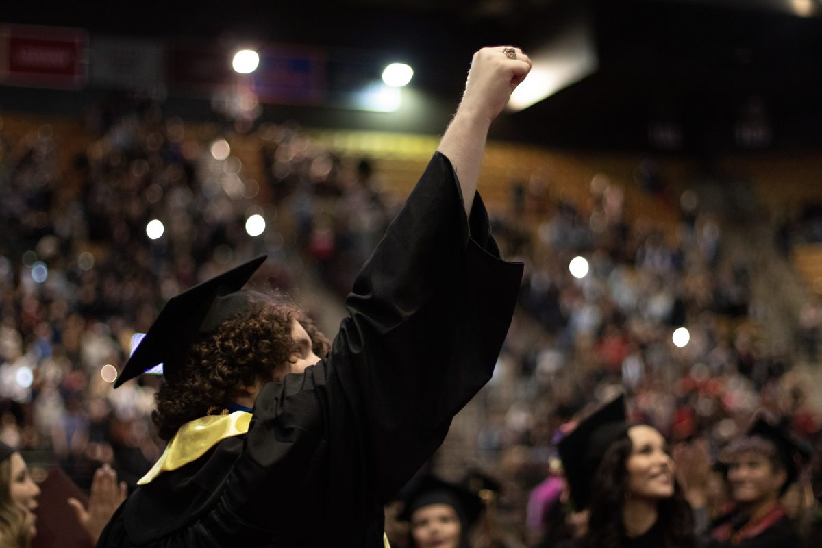 Texas State graduates celebrate at the end of the commencement ceremony, Saturday, Dec. 11, 2021, at Strahan Arena.