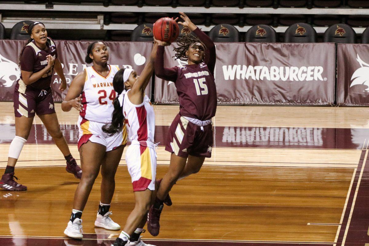 Texas State then-junior guard JaKayla Bowie (15) pushes through defenders to get an open shot during the game against the University of Louisiana Monroe, Saturday, Jan. 23, 2021, at Strahan Arena. The Bobcats won 64-50.
