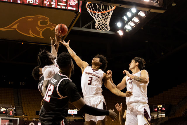 Texas State Bobcats fight for possession of the ball during a game against Lamar University, Wednesday, Dec. 15, 2021, at Strahan Arena. The Bobcats won 67-47.