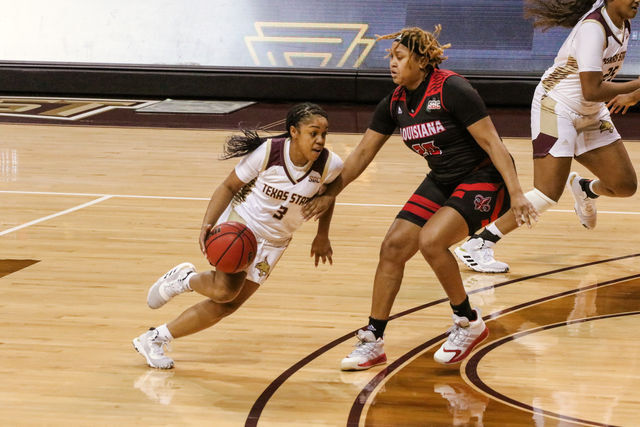 Texas State then-junior guard Kennedy Taylor (3) dribbles past a University of Louisiana defender to get to the basket, Friday, Jan. 1, 2021, at Strahan Arena.
