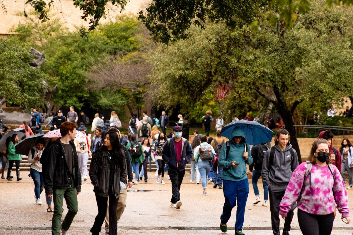 Texas State students walk to their classes on the first day back on campus for the spring semester, Monday, Jan. 31, 2022, on The Quad.