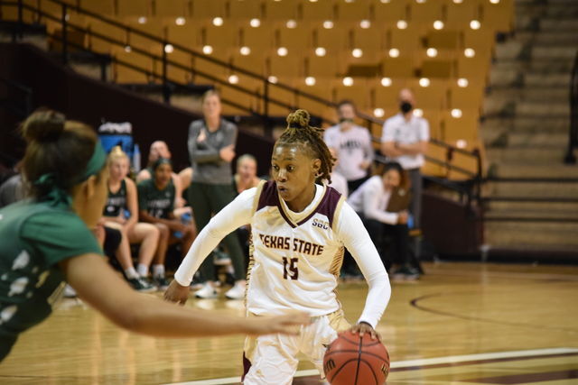 <p>Texas State senior guard Ja'Kayla Bowie (15) dribbles the ball against during a game against Dartmouth College, Thursday, Dec. 16, 2021, at Strahan Arena. The Bobcats lost 62-39.</p>