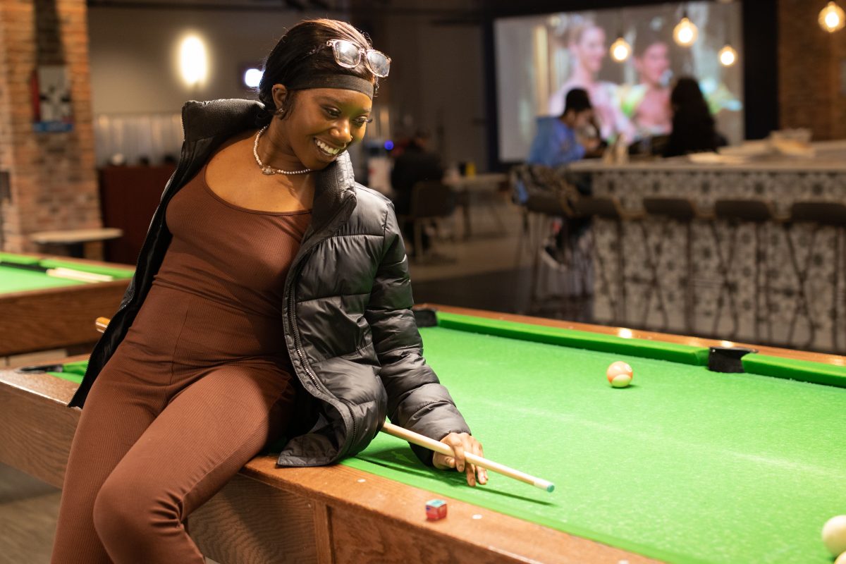 Biology freshman Ivanna Awodipe hits the cue ball in a game of pool, Monday, Jan. 31, 2022, at Georges.