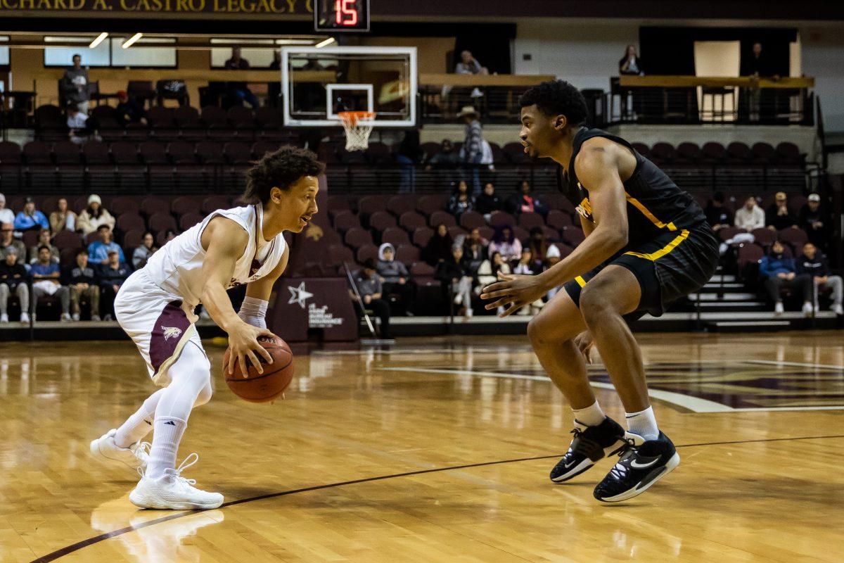 Texas State senior guard Mason Harrell (12) attempts to dribble around a Mountaineer defender during a game against Appalachian State, Thursday, Feb. 3, 2022, at Strahan Arena. The Bobcats won 68-66.
