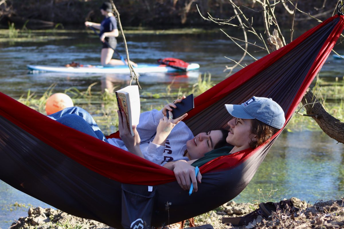 Texas State English sophomore Megan Sewell and English freshman Cooper Haack read books together in a hammock, Friday, Feb. 11, 2022, at Sewell Park. Sewell and Haack met through mutual friends and have been a couple for over a year and a half.