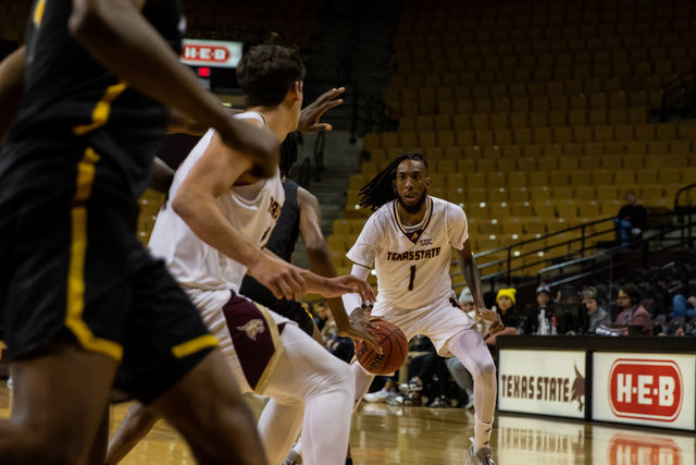 Texas State senior forward Isiah Small (1) looks for an open pass through the Mountaineer defense during a game against Appalachian State, Thursday, Feb. 3, 2022, at Strahan Arena. The Bobcats won 68-66.