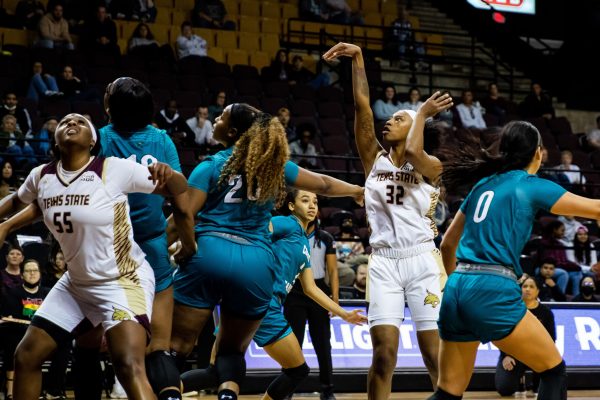 Texas State senior forward Da'Nasia Hood (32) takes a shot for the basket during a game against Coastal Carolina, Saturday, Feb. 5, 2022, at Strahan Arena. The Bobcats won 64-59.