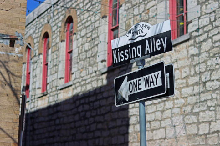 A photo of the Kissing Alley street sign, Saturday, Feb. 5, 2022, at Kissing Alley.
