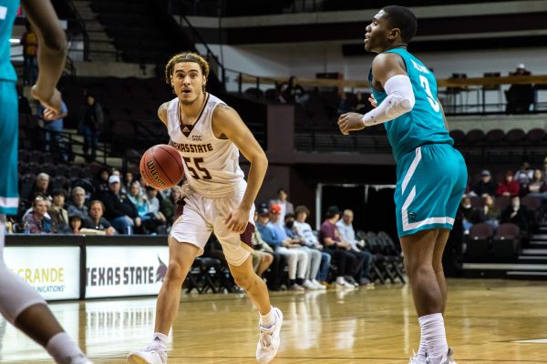 Texas State junior guard Drue Drinnon (55) looks for an open pass through the Chanticleers' defense during a game against Coastal Carolina, Sat. Feb 5, 2022, at Strahan Arena. The Bobcats won 69-64.